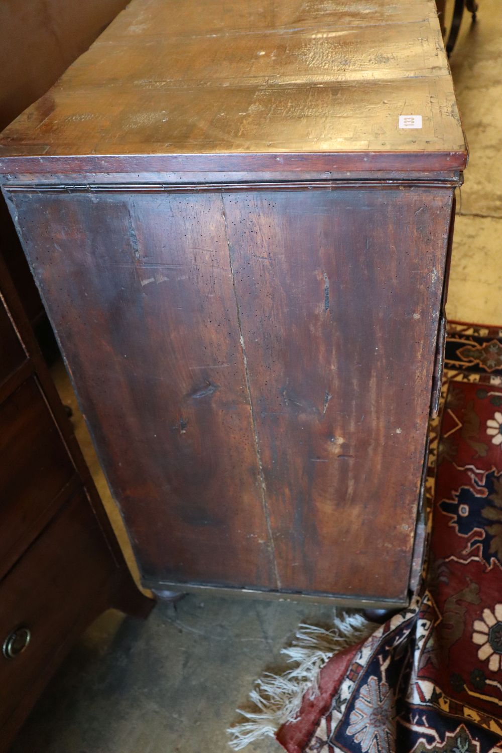 An early to mid 18th century chest with later top, two short and three long drawers, on later bun feet, width 101cm